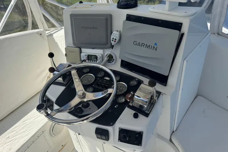 Slide: The Image of Helm of 1965 Hatteras 41 Convertible with Garmin and Raymarine navigation systems. - 24