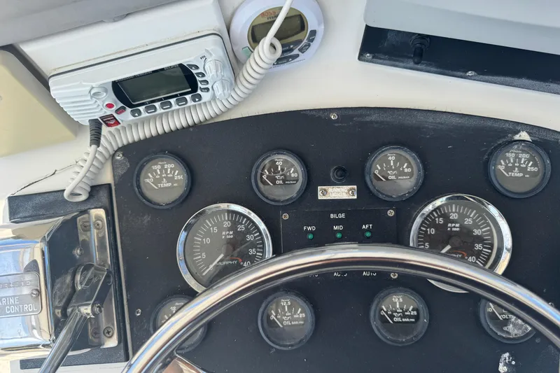Slide: The Image of Dashboard of a 1965 Hatteras 41 Convertible boat with gauges and radio equipment. - 25