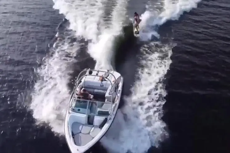 Slide: The Image of 2004 Correct Craft Super Air Nautique towing a wakeboarder on a lake. - 18