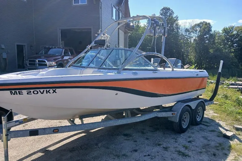 Slide: The Image of 2004 Correct Craft Super Air Nautique boat on trailer, parked outdoors. - 20