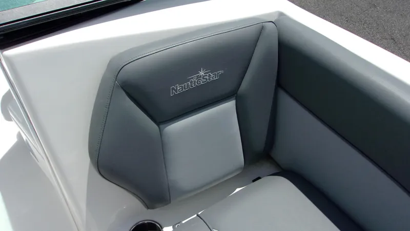 Slide: The Image of 2023 NauticStar 203 DC boat interior with gray cushioned seating. - 12