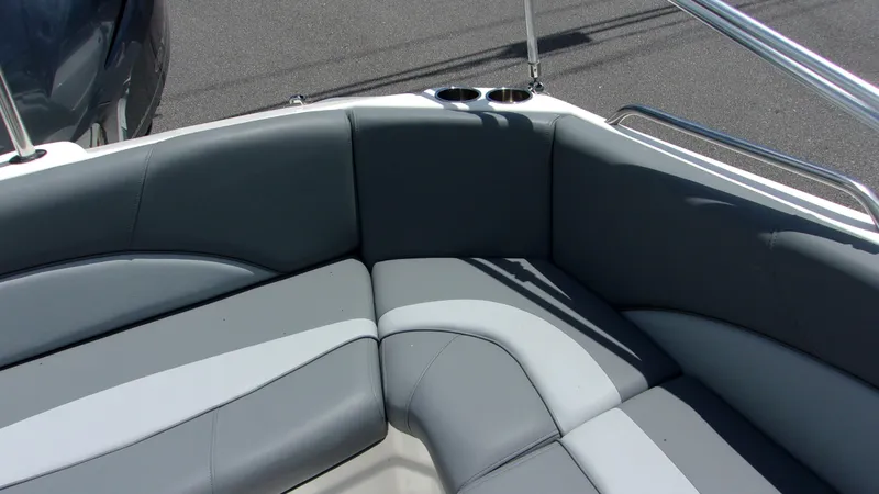 Slide: The Image of 2023 NauticStar 203 DC boat interior with gray cushioned seating and cup holders. - 13