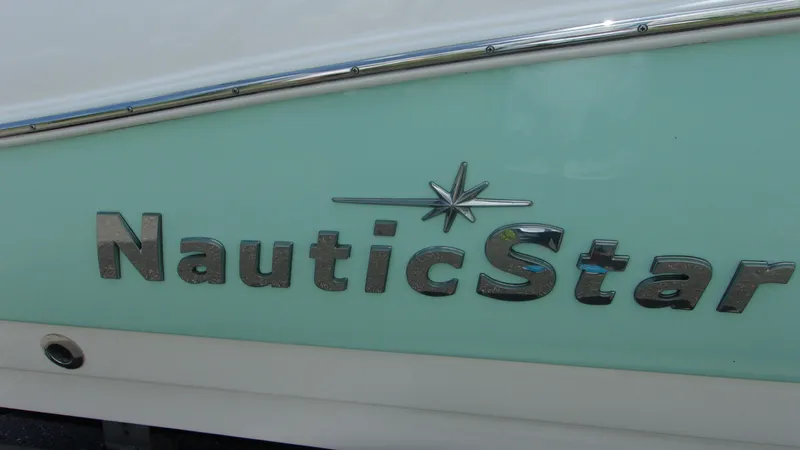 Slide: The Image of 2023 NauticStar 203 DC boat logo on light blue hull. - 19