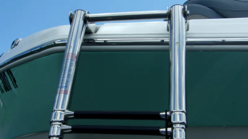 Slide: The Image of Stainless steel ladder on 2023 NauticStar 203 DC boat against blue sky. - 3