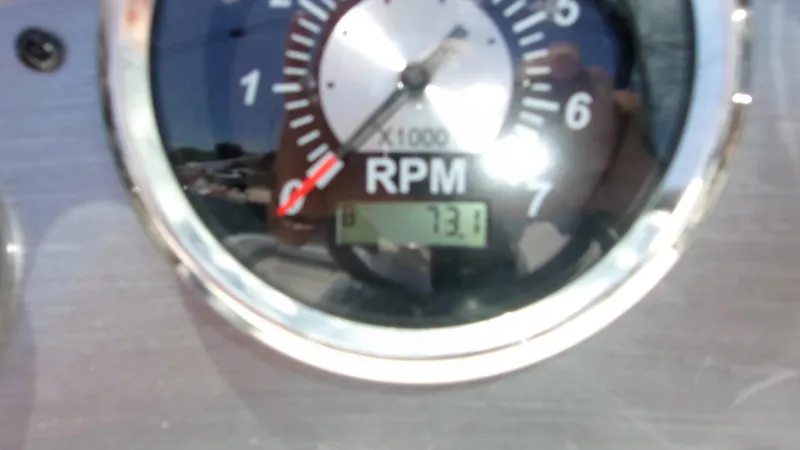 Slide: The Image of Close-up of 2023 NauticStar 203 DC RPM gauge showing 73.1 hours. - 5