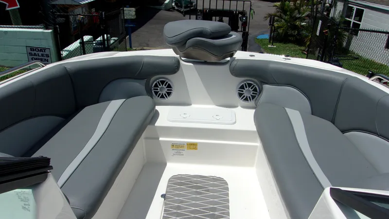 Slide: The Image of 2023 NauticStar 203 DC boat interior with gray seating and speakers. - 7