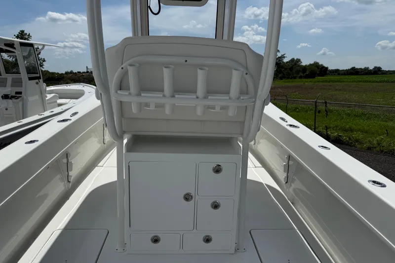 Slide: The Image of 2026 Pair Customs 28 Center Console boat interior with Garmin navigation, American flag visible. - 10