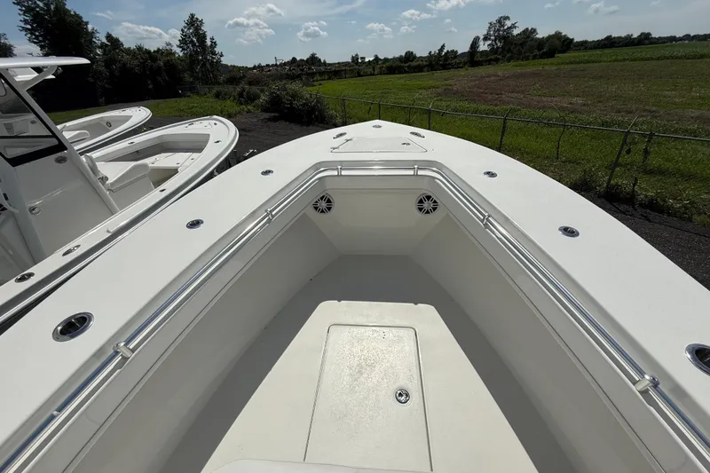 Slide: The Image of 2026 Pair Customs 28 Center Console boat with white storage compartments. - 17