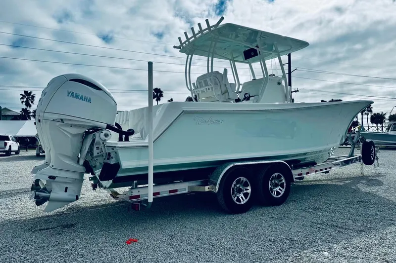 Slide: The Image of 2026 Pair Customs 28 Center Console boat on trailer with twin Yamaha engines. - 2