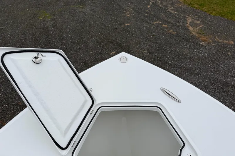 Slide: The Image of 2026 Pair Customs 28 Center Console boat, white deck, parked near garage. - 23