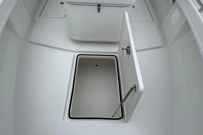 Slide: The Image of 2026 Pair Customs 28 Center Console boat with open storage compartment on deck. - 25