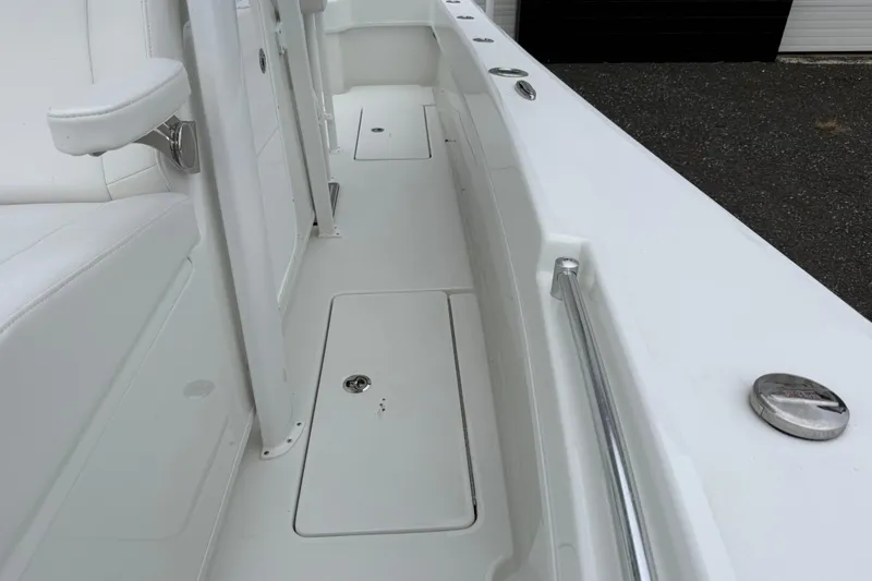 Slide: The Image of 2026 Pair Customs 28 Center Console boat with open storage compartment. - 27