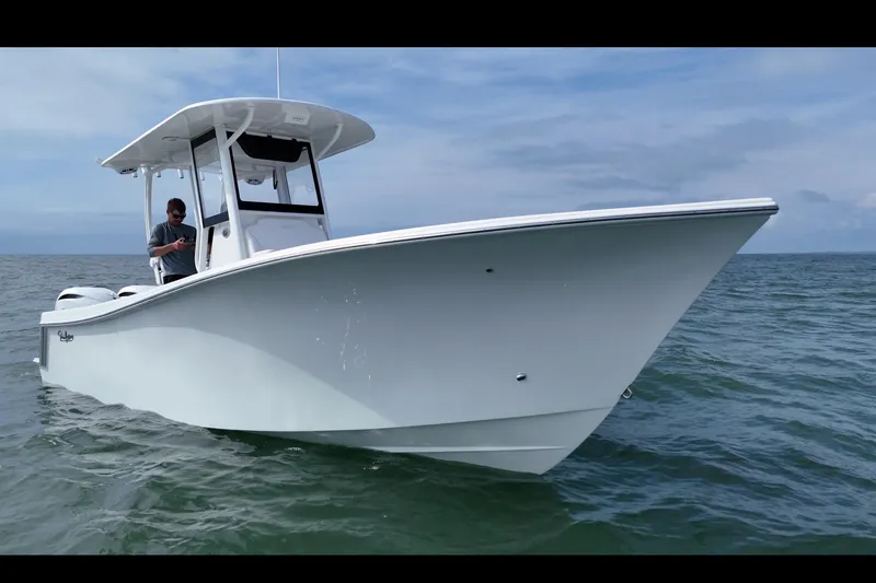 Slide: The Image of 2026 Pair Customs 28 Center Console with dual Yamaha V6 outboard engines, rear view. - 3