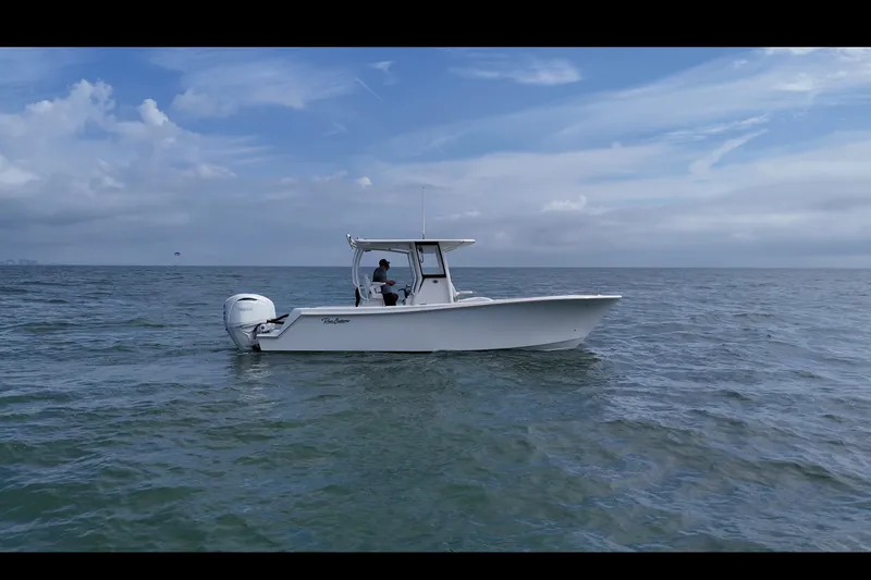 Slide: The Image of 2026 Pair Customs 28 Center Console boat on trailer outside building. - 5