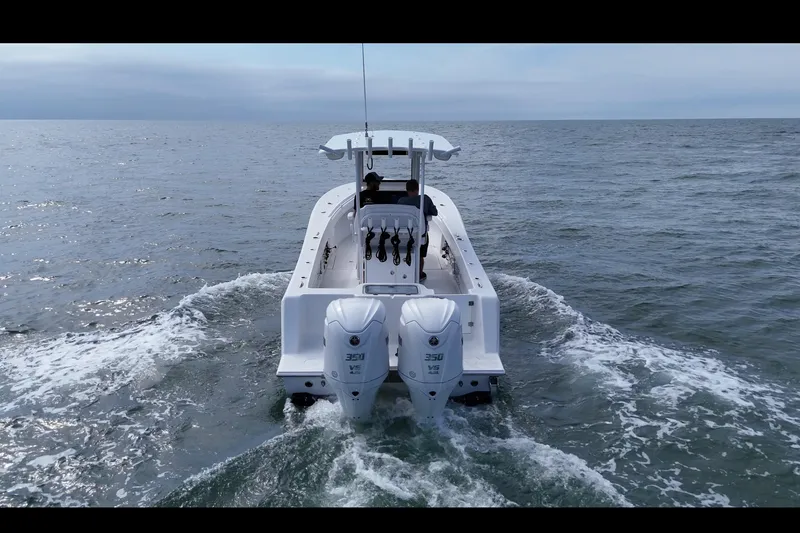 Slide: The Image of 2026 Pair Customs 28 Center Console boat with white seating and steering wheel. - 8