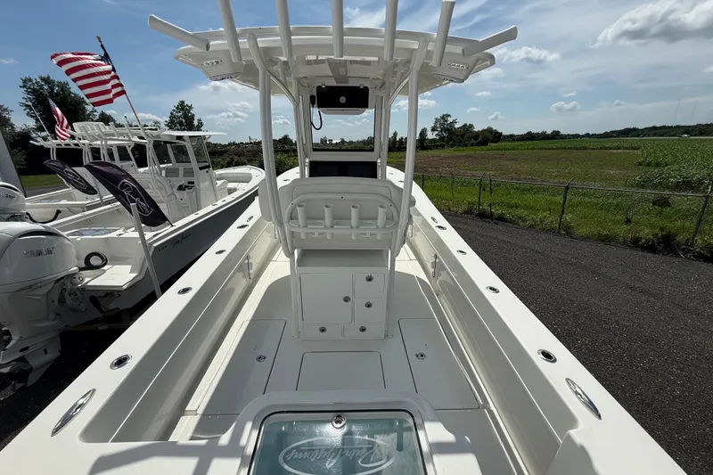 Slide: The Image of 2026 Pair Customs 28 Center Console boat with Garmin navigation system, steering wheel, and controls. - 9