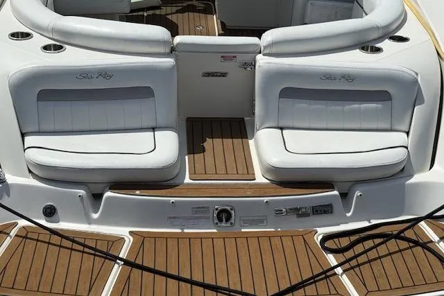 Slide: The Image of 2012 Sea Ray 300 Sundeck boat interior with white seating and teak flooring. - 10