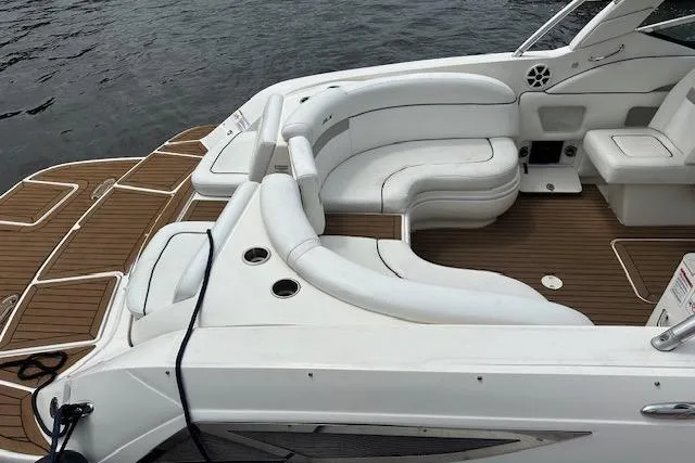 Slide: The Image of 2012 Sea Ray 300 Sundeck boat with spacious white seating and teak flooring. - 9