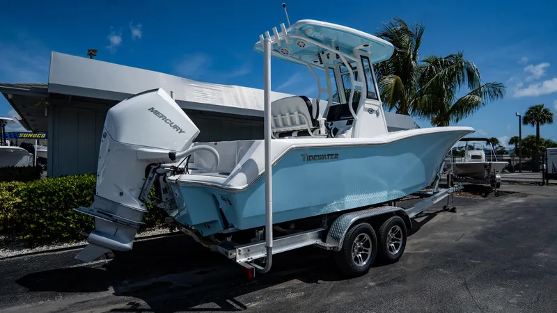 Slide: The Image of 2025 Tidewater 232 CC Adventure boat on trailer, side view. - 1