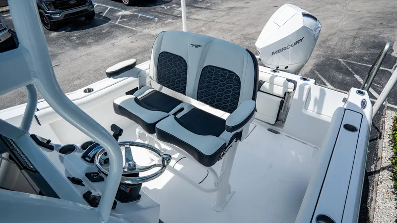 Slide: The Image of 2025 Tidewater 232 CC Adventure boat interior with dual seating and Mercury outboard engine. - 10