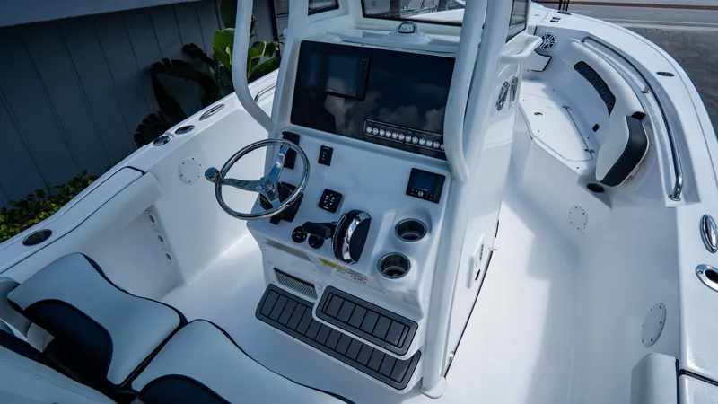 Slide: The Image of 2025 Tidewater 232 CC Adventure boat cockpit with modern controls and seating. - 11