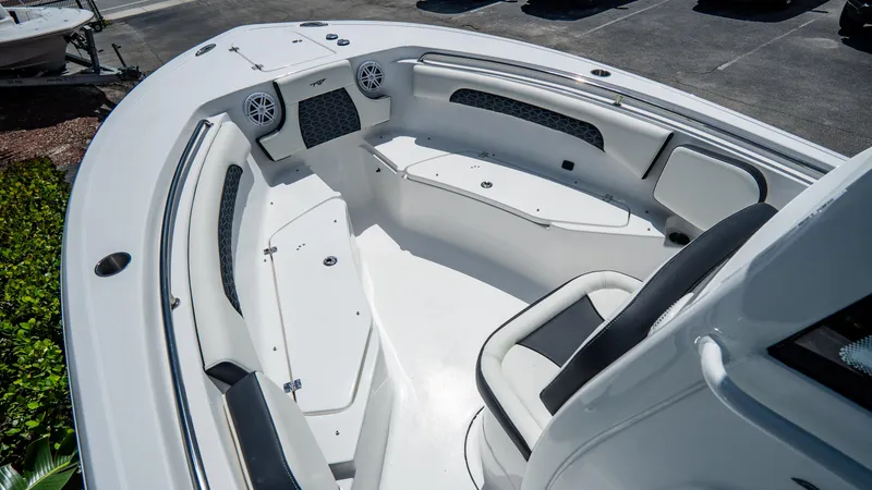 Slide: The Image of 2025 Tidewater 232 CC Adventure boat interior with seating and storage compartments. - 18