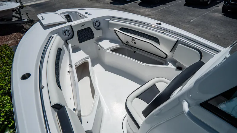 Slide: The Image of 2025 Tidewater 232 CC Adventure boat interior with seating and storage compartments. - 19