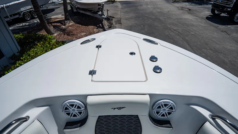 Slide: The Image of 2025 Tidewater 232 CC Adventure boat bow with storage hatch and speakers. - 20