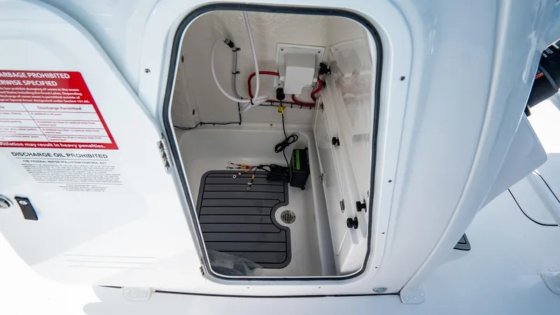 Slide: The Image of 2025 Tidewater 232 CC Adventure storage compartment with wiring and equipment. - 23