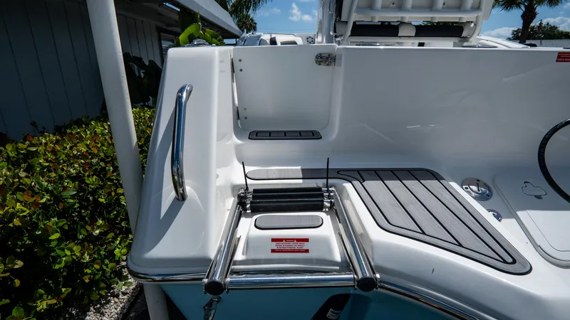 Slide: The Image of 2025 Tidewater 232 CC Adventure boat swim platform with ladder and handrail. - 5