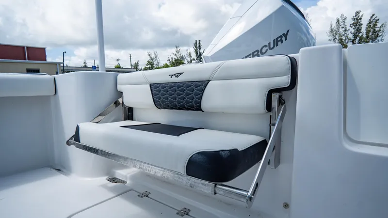 Slide: The Image of 2025 Tidewater 232 CC Adventure boat with foldable seating and Mercury engine. - 7