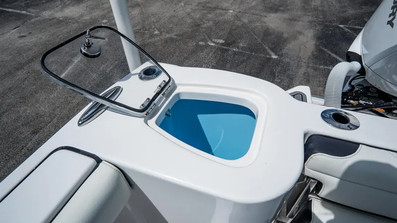 Slide: The Image of 2025 Tidewater 232 CC Adventure boat livewell and seating area. - 8