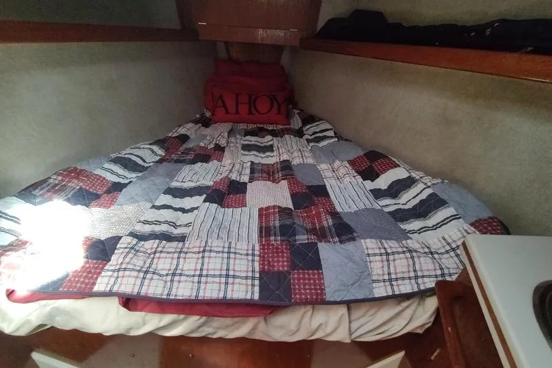 Slide: The Image of Cozy cabin bed in 1987 Hunter 37 Legend sailboat with patchwork quilt. - 47