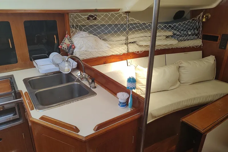 Slide: The Image of Interior of 1987 Hunter 37 Legend sailboat with kitchen sink and cozy seating area. - 25