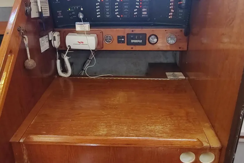 Slide: The Image of Navigation station of 1987 Hunter 37 Legend sailboat with control panel and communication equipment. - 37