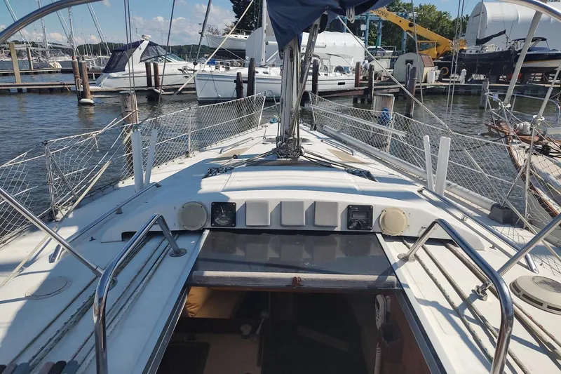 Slide: The Image of 1987 Hunter 37 Legend sailboat docked at marina, featuring deck and rigging. - 16