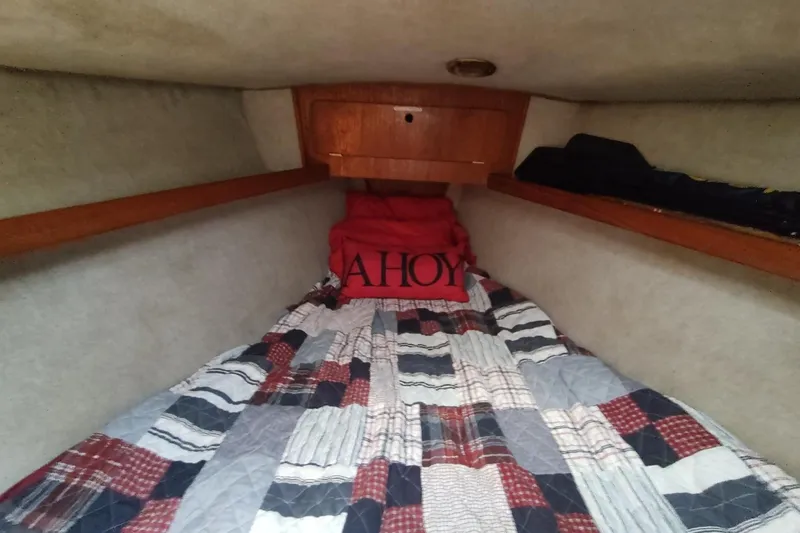Slide: The Image of Cozy cabin interior of 1987 Hunter 37 Legend sailboat with patchwork bedding. - 48