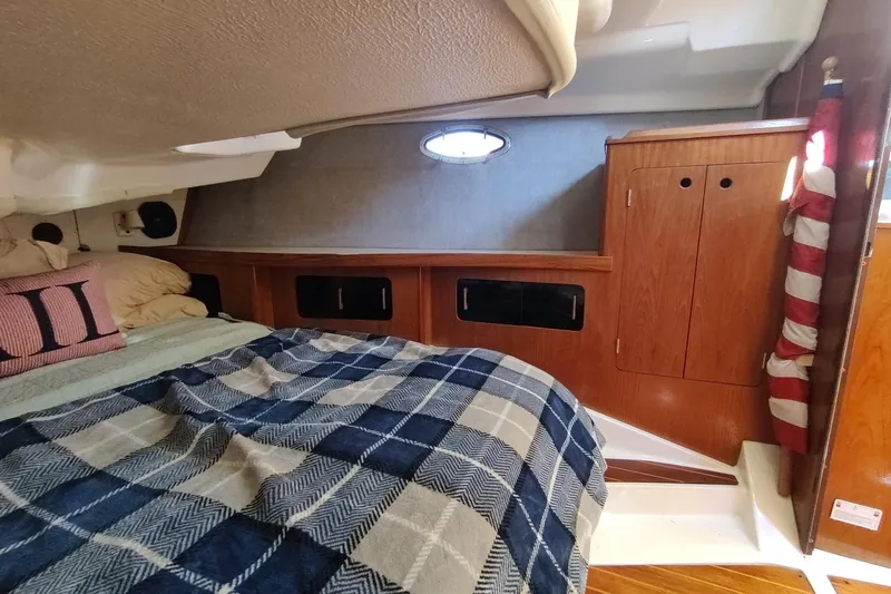 Slide: The Image of Cozy cabin interior of 1987 Hunter 37 Legend sailboat with plaid bedding and wooden cabinetry. - 27