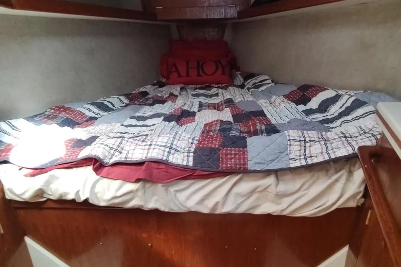 Slide: The Image of Cozy cabin bed in 1987 Hunter 37 Legend sailboat with patchwork quilt and "Ahoy" pillow. - 49