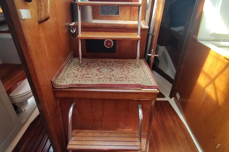 Slide: The Image of Interior of 1987 Hunter 37 Legend sailboat with wooden steps and carpeted platform. - 39