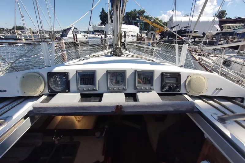 Slide: The Image of Cockpit view of 1987 Hunter 37 Legend sailboat with navigation instruments and marina background. - 17