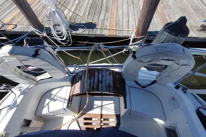 Slide: The Image of Cockpit of 1987 Hunter 37 Legend sailboat with life rings and dock view. - 5