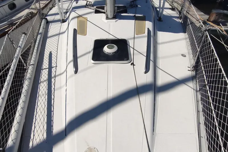Slide: The Image of 1987 Hunter 37 Legend sailboat deck with safety netting and hatch. - 18