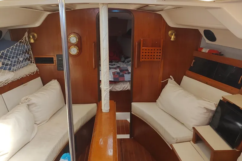 Slide: The Image of Interior of 1987 Hunter 37 Legend sailboat with cozy seating and wooden finishes. - 40