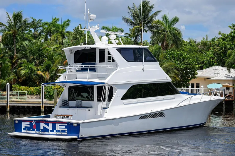 Slide: The Image of 2001 Viking 65 Enclosed Bridge yacht docked near tropical foliage. - 13