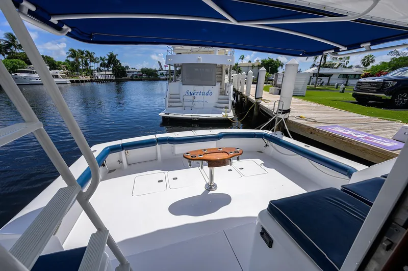 Slide: The Image of 2001 Viking 65 Enclosed Bridge yacht docked, featuring spacious deck and seating area. - 20