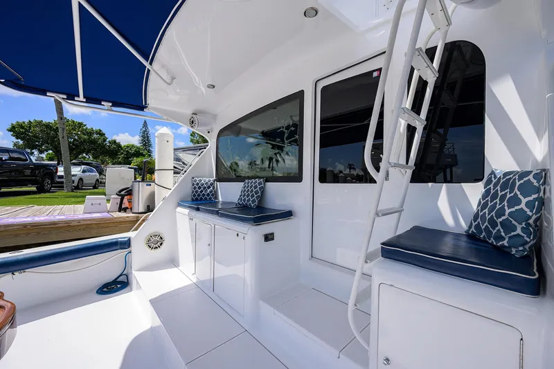 Slide: The Image of 2001 Viking 65 Enclosed Bridge yacht interior with seating, cushions, and ladder. - 26