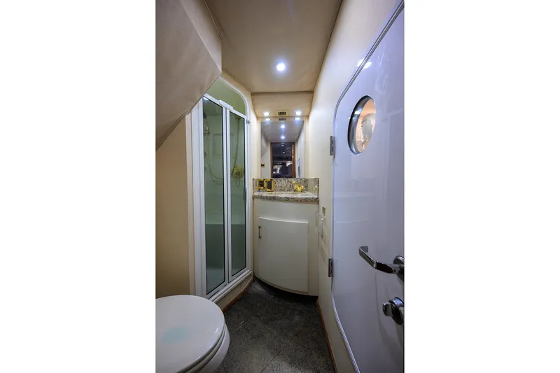 Slide: The Image of Luxurious bathroom interior of 2001 Viking 65 Enclosed Bridge yacht with shower and vanity. - 29