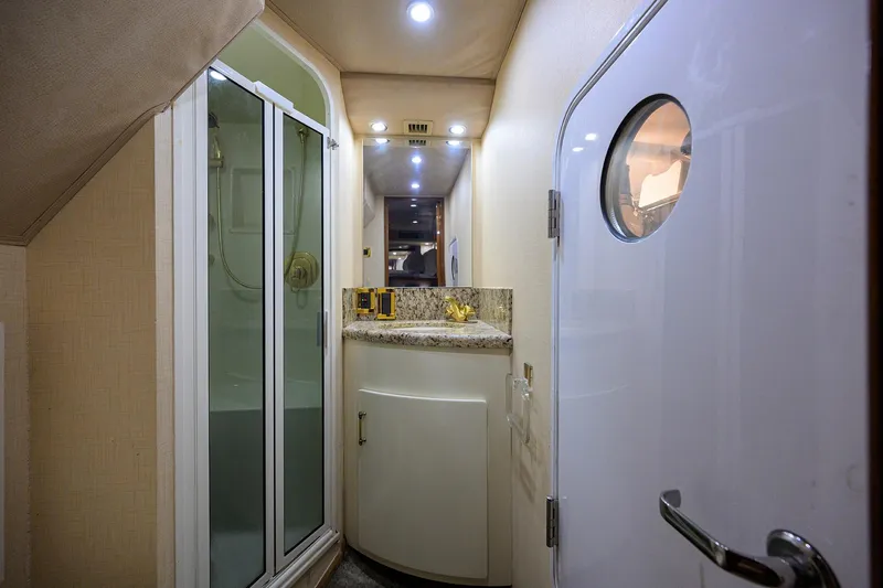 Slide: The Image of Interior of 2001 Viking 65 Enclosed Bridge yacht bathroom with shower and vanity. - 30