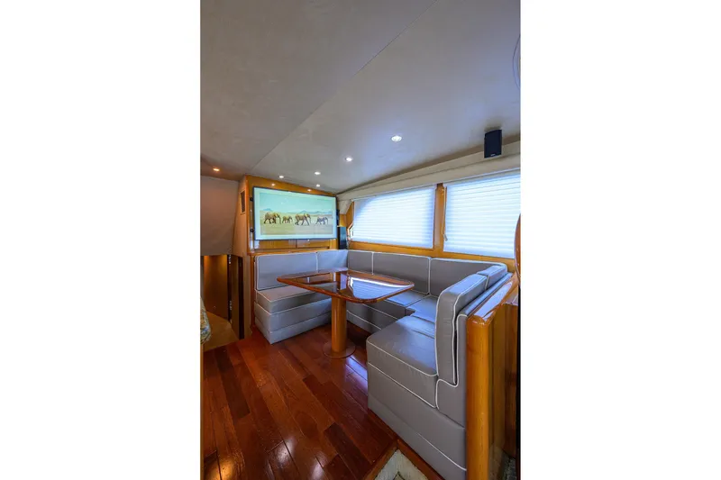 Slide: The Image of Luxurious interior of 2001 Viking 65 Enclosed Bridge yacht with elegant seating and wooden flooring. - 32